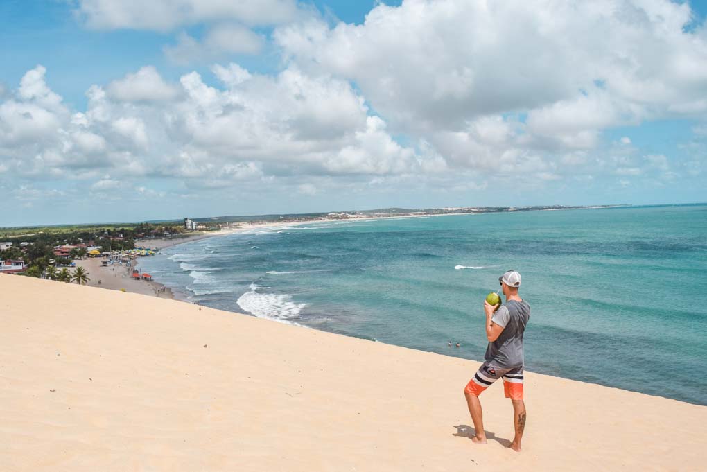 Drinking a coconut on the sand dunes of Natal, Brazil