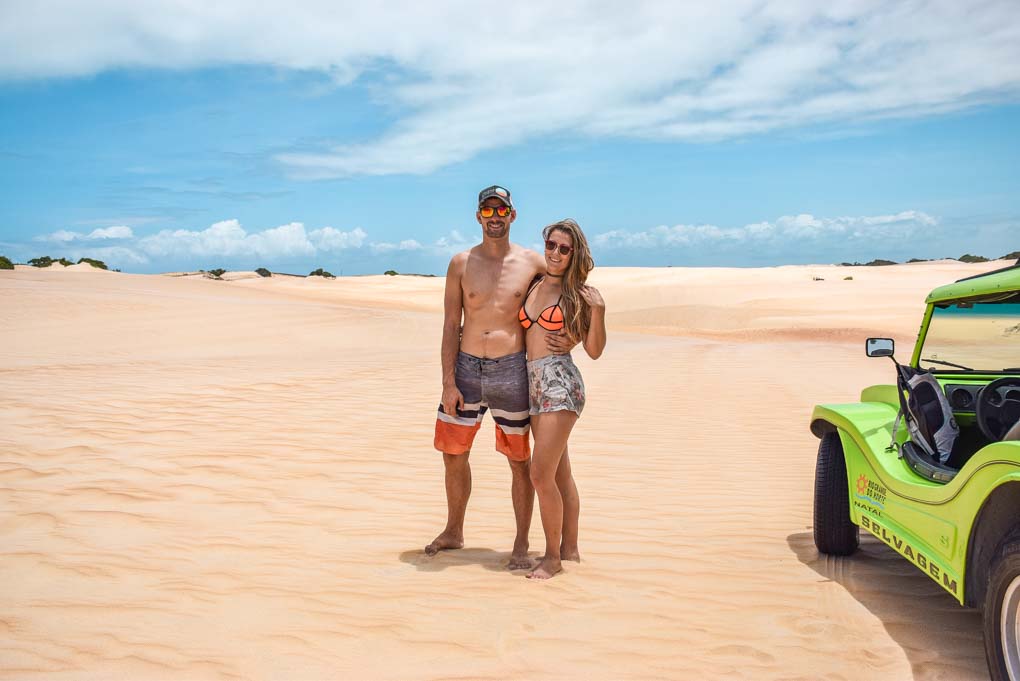 Bailey and daniel stand next to their dune buggy on the tour from Natal, Brazil