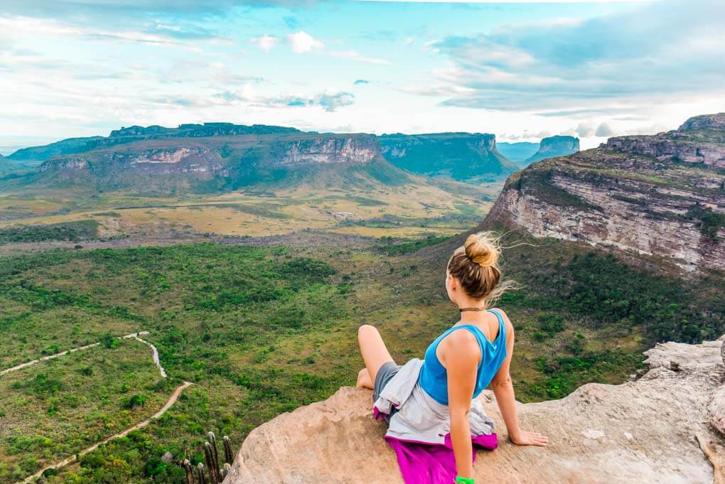 Bailey sits on the edge of a cliff at Morro Do Pai Inacio in Chapada Diamantina National Park, Brazil