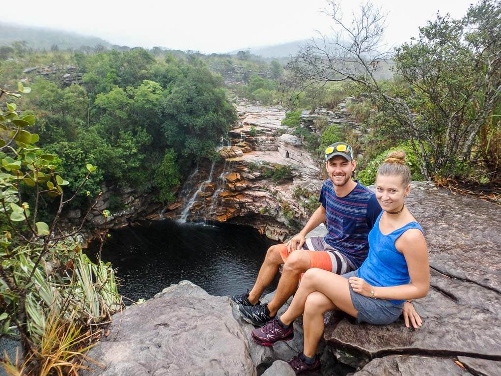 Dan and Bailey sit at the top of Poco do Diabo, Brazil