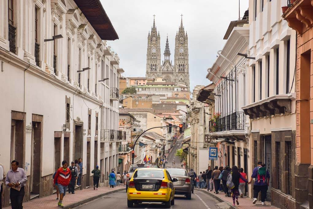 A photo of cars driving down a road in the Historic Center of Quito