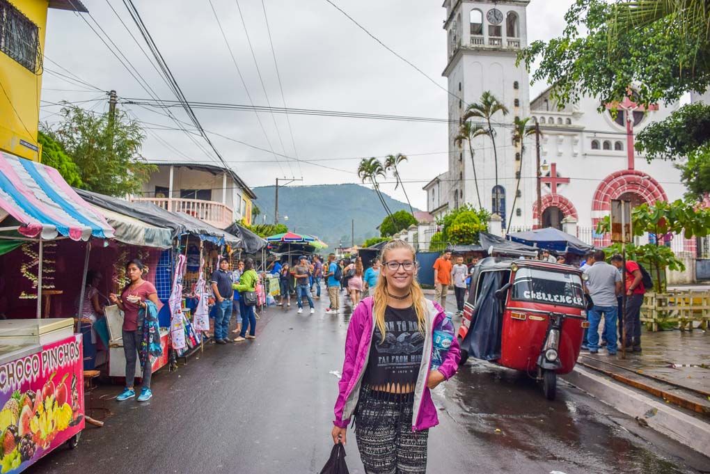 A lady walks down a street in the town of Juayua on the Ruta de las Flores