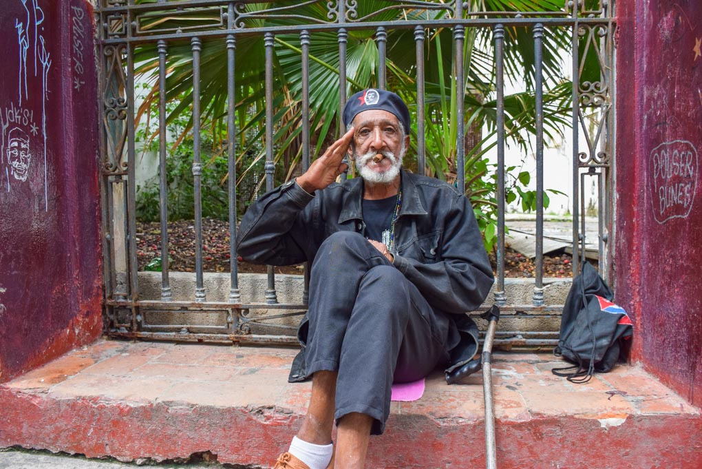 A man dressed up on the streets poses for a photo in Cuba