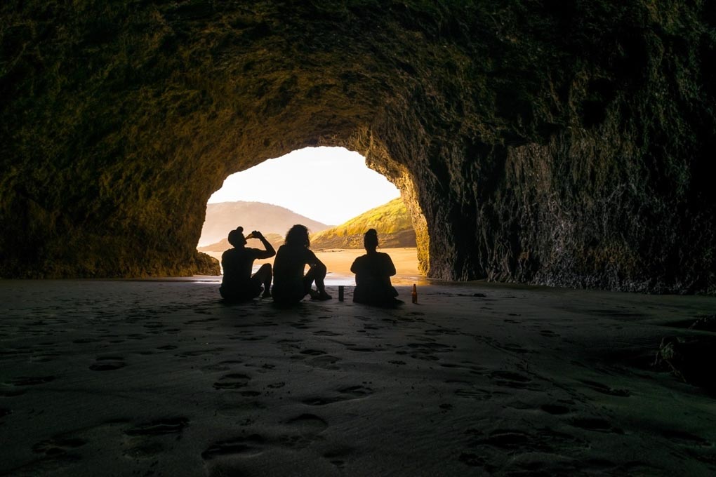 Sitting in the Bethells Beach Cave