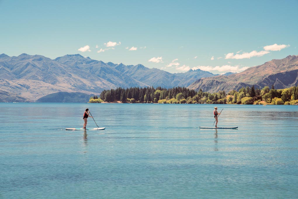 People paddle boarding on Lake Wanaka, New Zealand