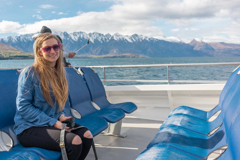 Bailey sits on the Spirit of Queenstown Scenic Cruise with the Remarkables mountain range in the background