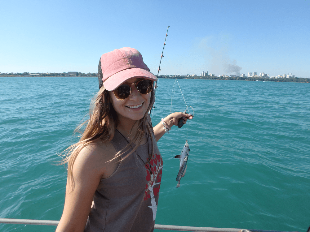 Bailey catching a fish in a fishing boat