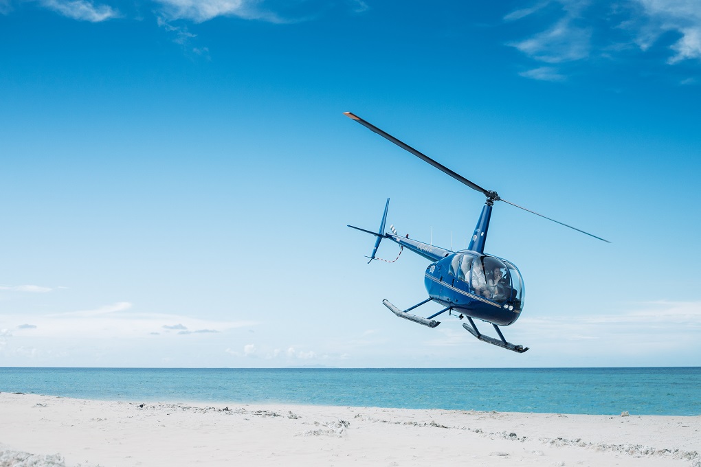 helicopter landing on a beach in Fiji