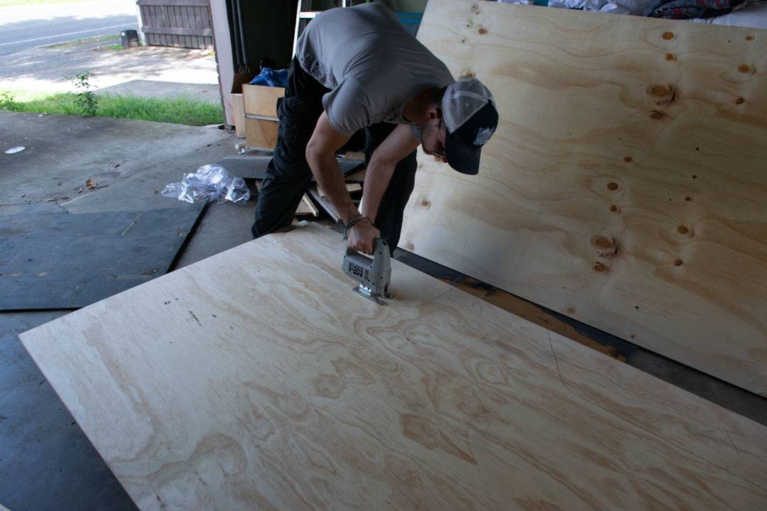 cutting out the floor while converting a van into a campervan