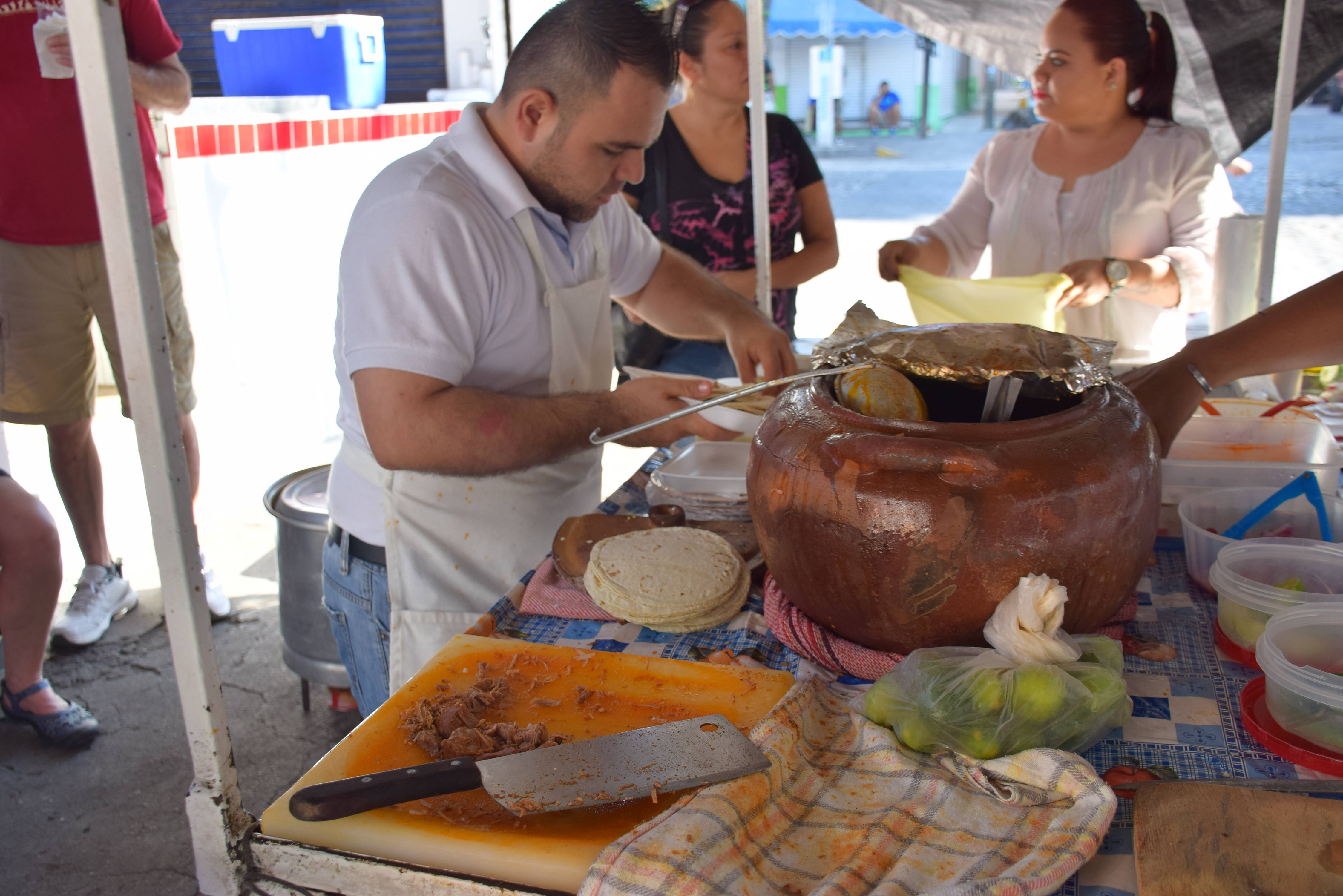 man at a taco stand in mexico