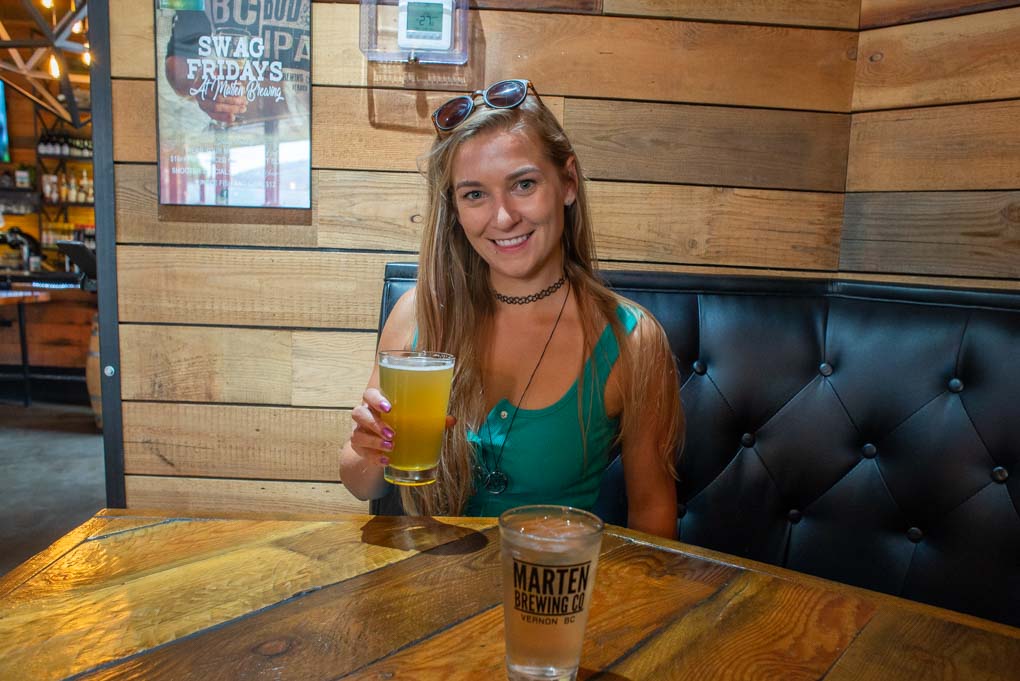 Bailey holding a berr at Marten Brew Pub, Vernon