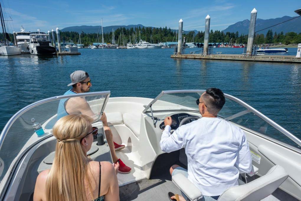 A group of friends go boating in Vancouver Harbor