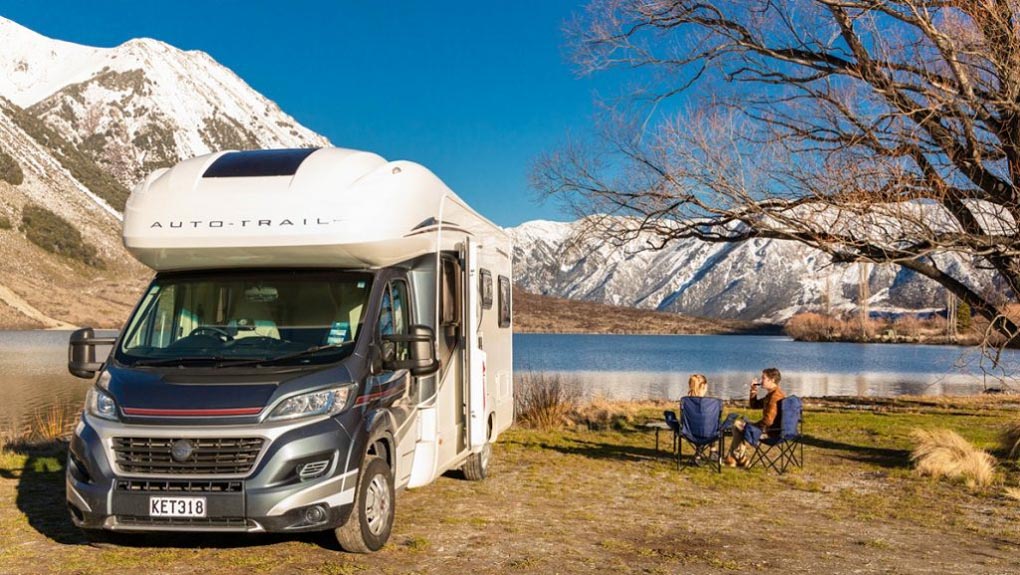 Two people having a picnic in their motorhome hire in NZ