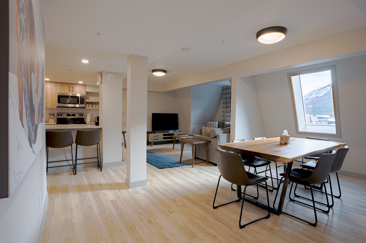 inside of an apartment at Basecamp Suites in Banff with a mountain out the window