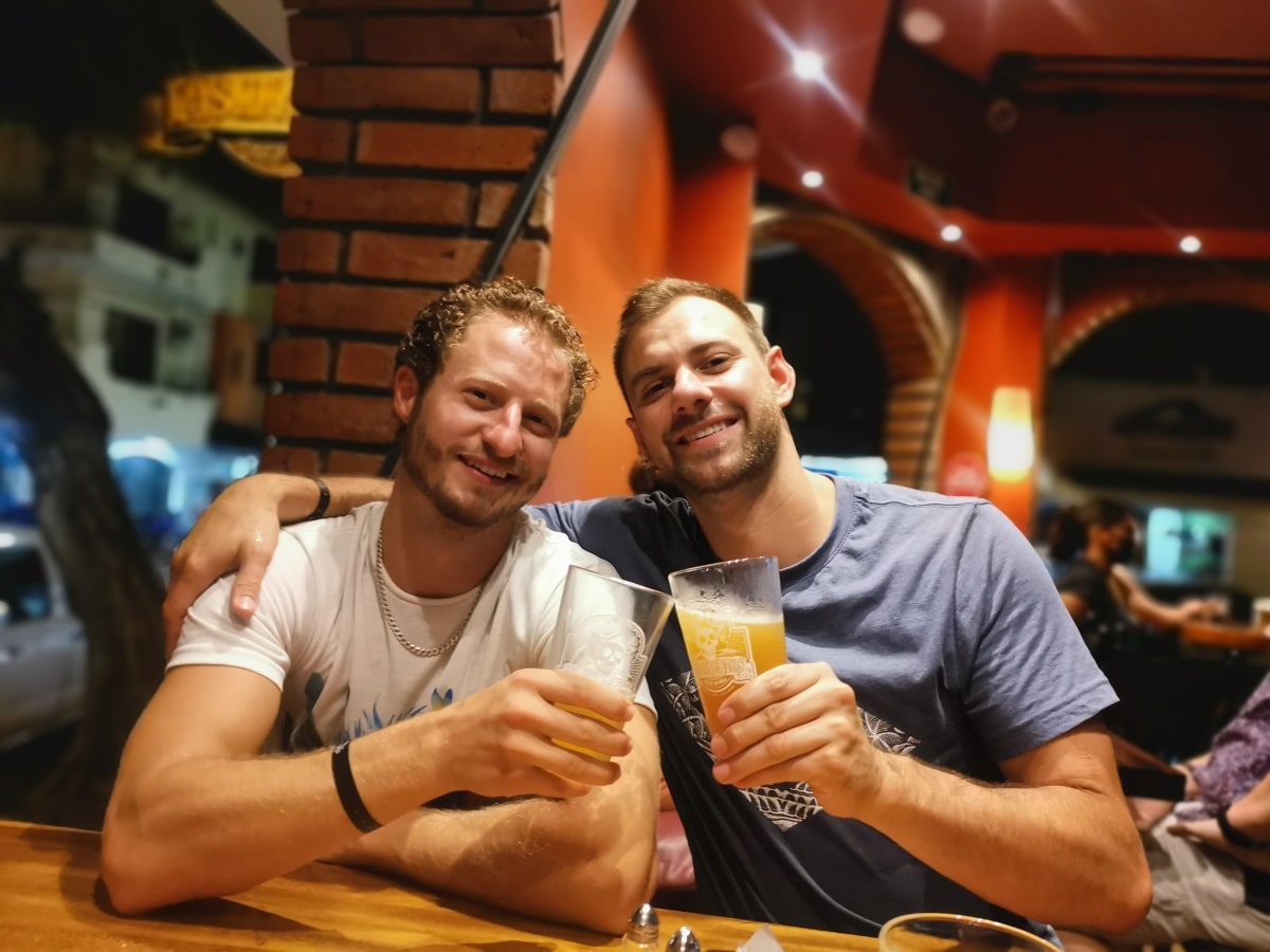 two men drinking beer at Los Muertos Brewing in Puerto Vallarta