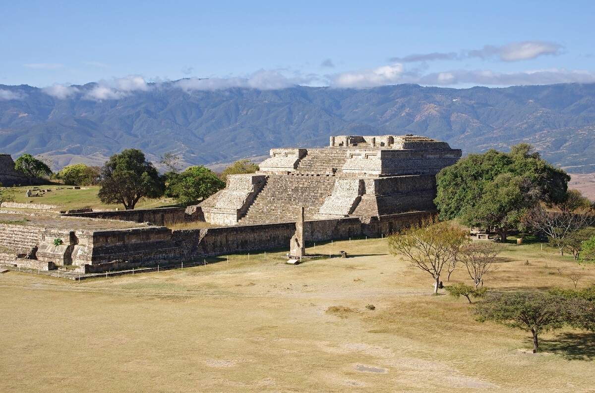 view of a ruin at Monte Alban with mountains in the background