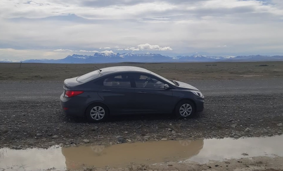 car parked on the side of a gravel road in patagonia