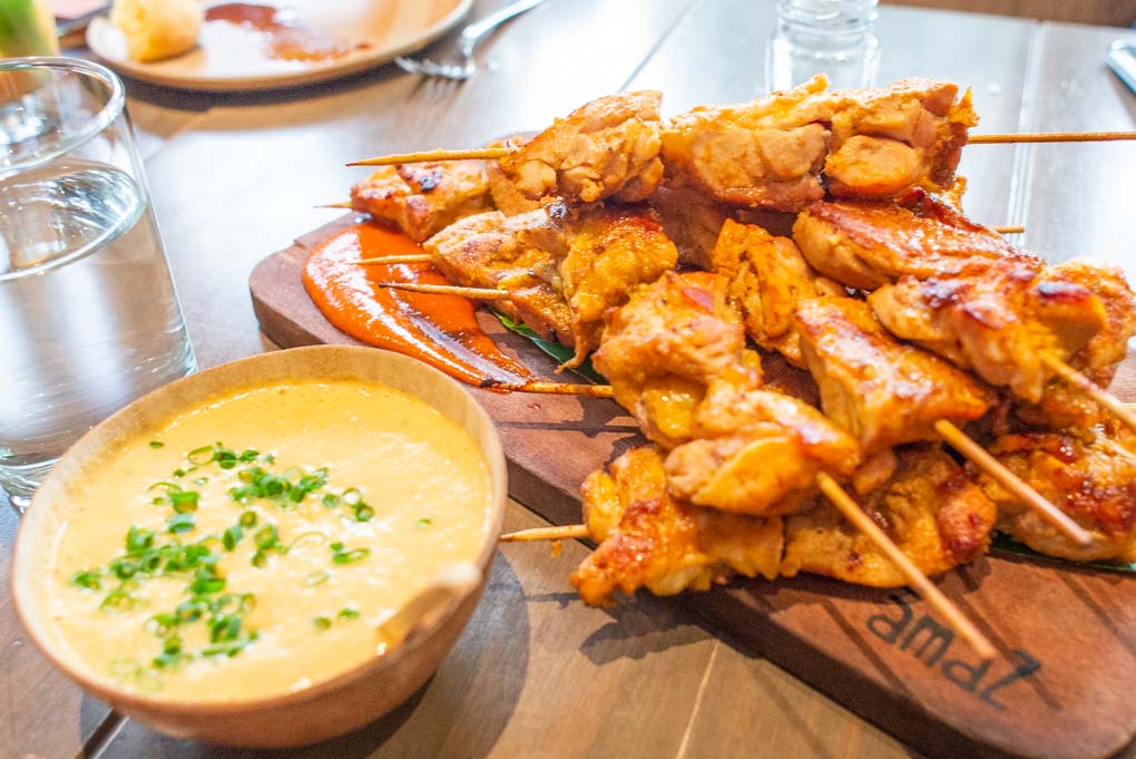 chicken skewers with dipping sauce in peru