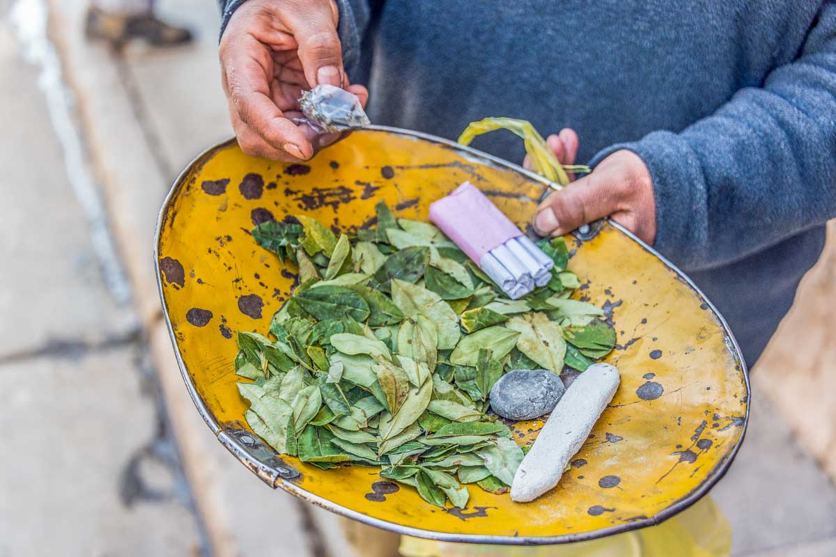 Coca leaves on a plate at a market in Peru