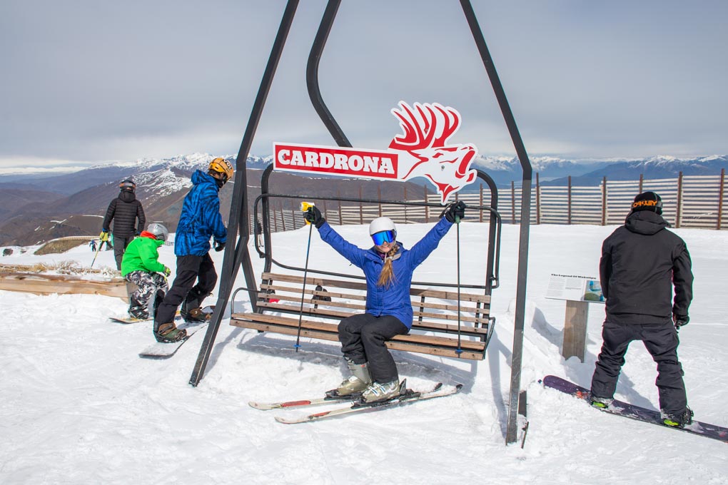 Bailey takes a photo with the Cardron Ski Filed sign