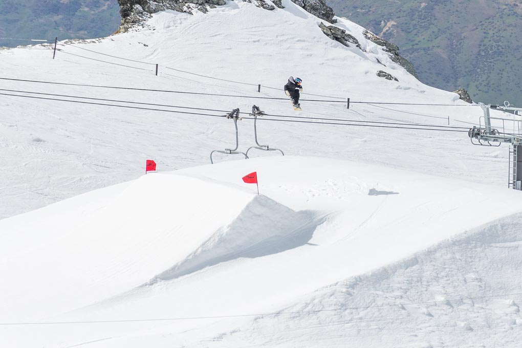 A pro snowboarder does a jump at Cardrona Ski Resort