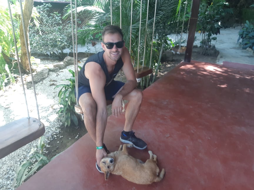 petting a dog at a hostel in minca colombia
