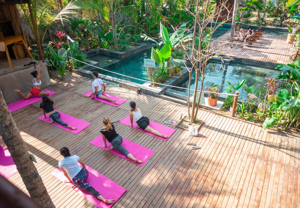 A yoga class by the pool at Costeño Beach Hostel, Colombia