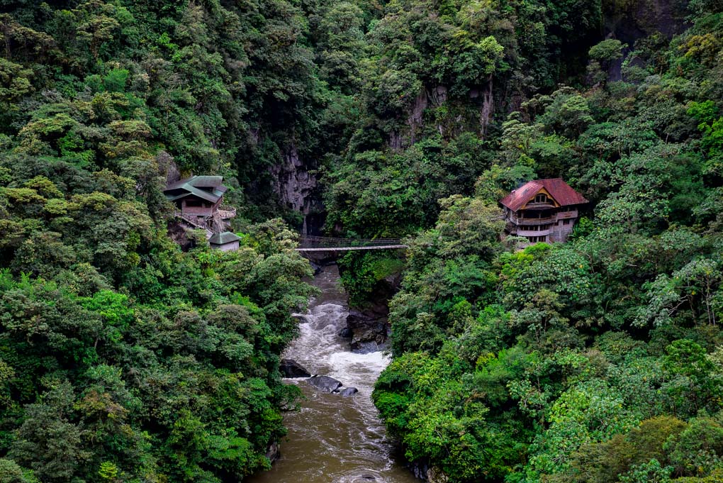 A bridge crosses a river in Banos, Ecuador