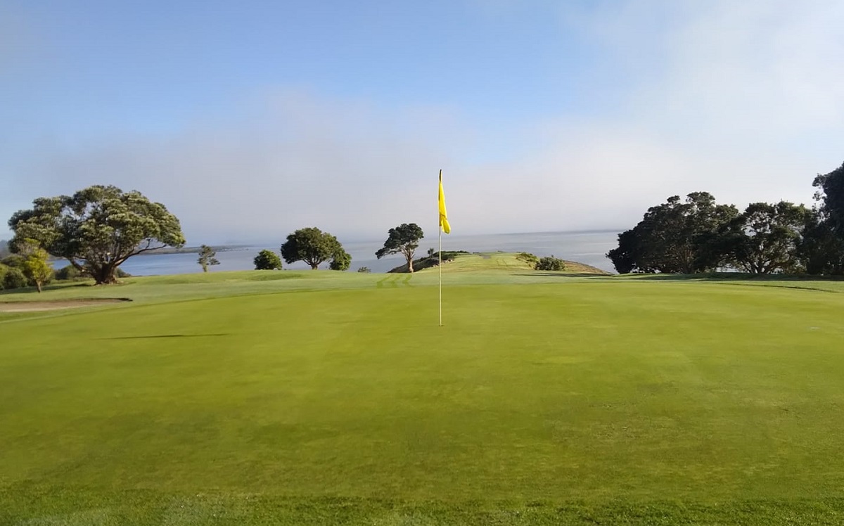 a hole and ocean view at Waitangi Golf Course