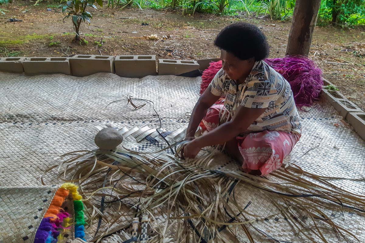 woman basket weaving in Fiji