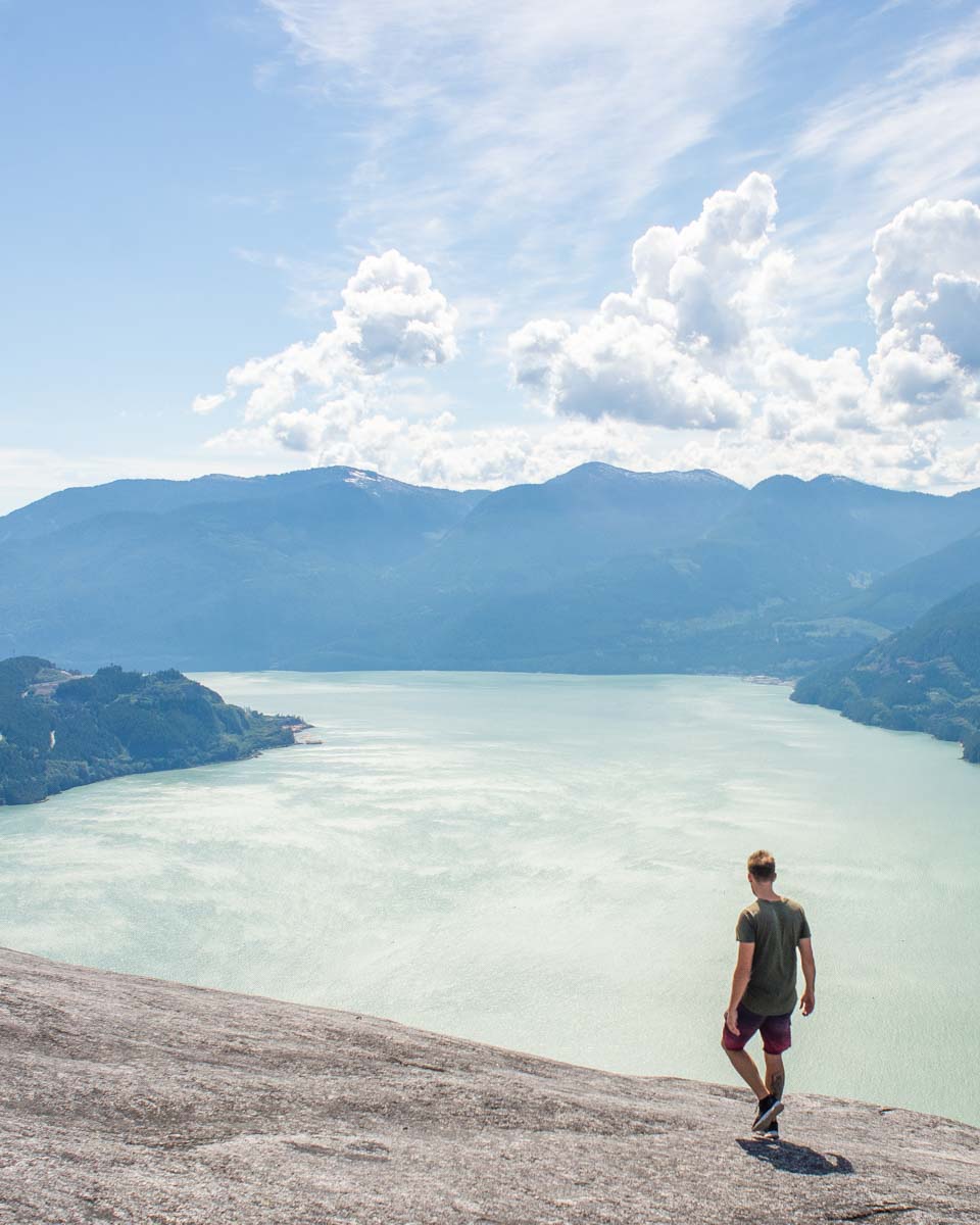 A man walks along the summit of Stawamus Chief