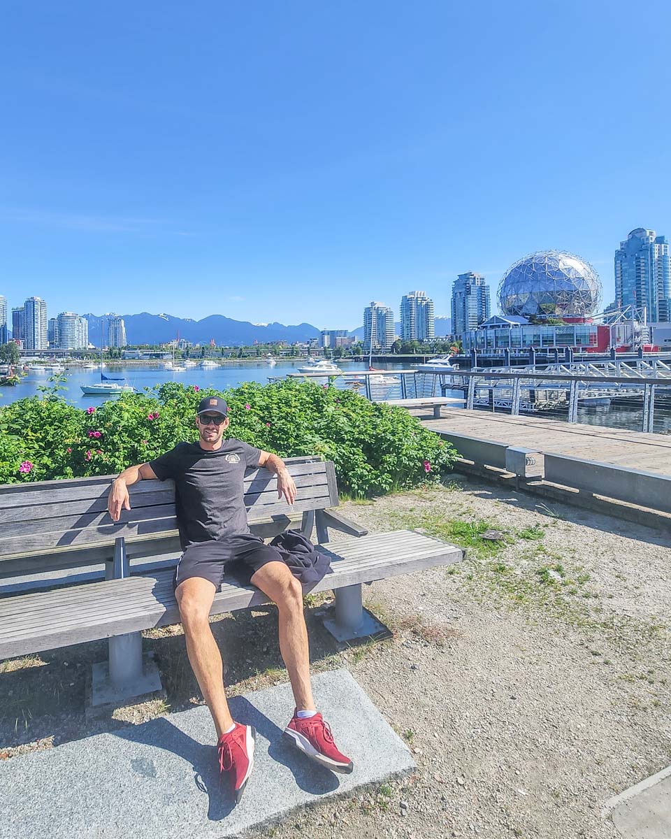 Daniel sits on a bench on the Vancouver Seawall