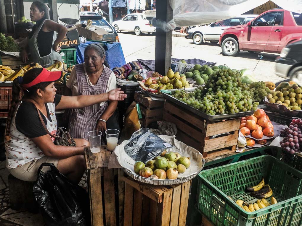 Two ladies sell vegetables in a market in Santa Cruz, Bolivia