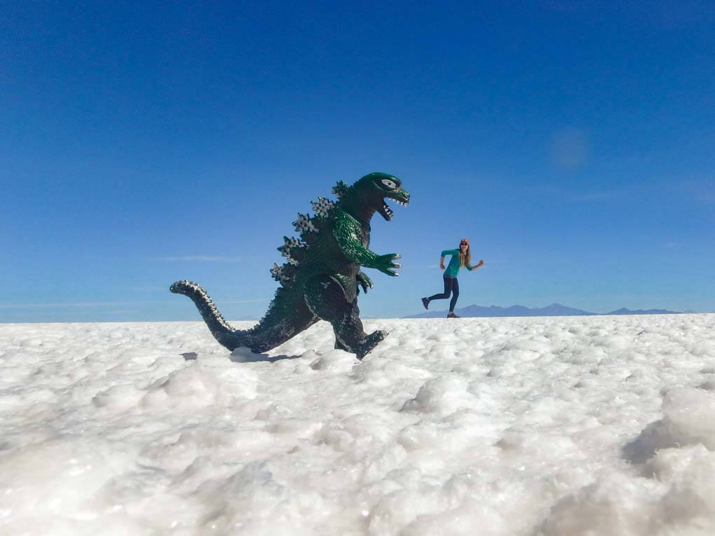 Bailey runs from a dinasaur while taking a silly photo using the salt flats