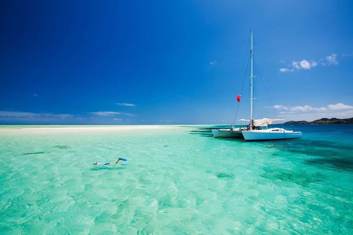 person snorkeling at a remote island in Fiji