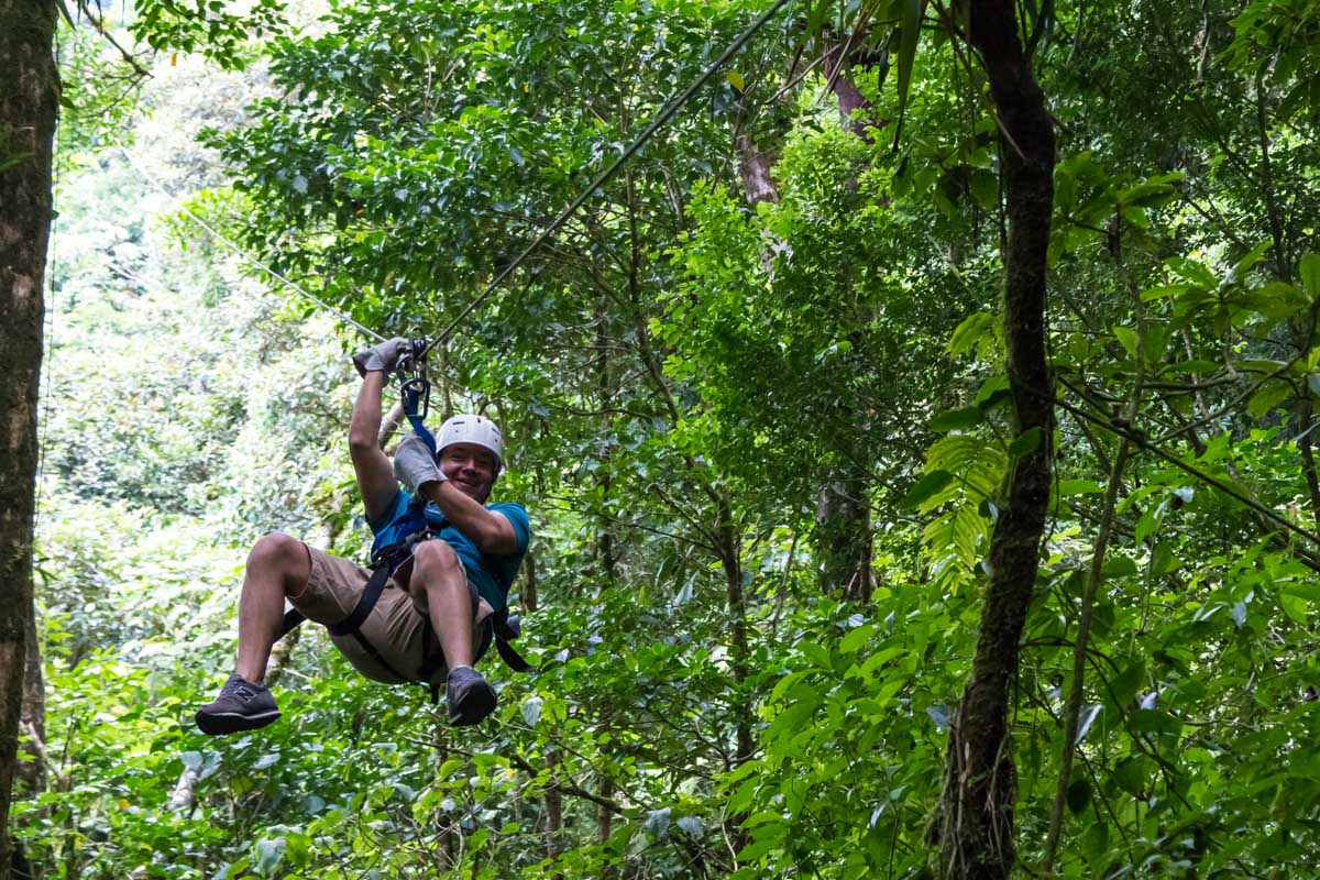 A-man-prepairs-to-stop-while-ziplining-in-puerto viejo costa rica