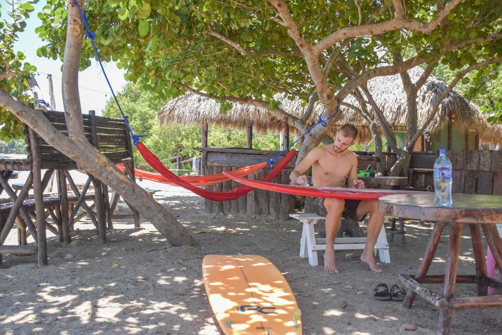 Daniel waxing his surfboard in San Juan del Sur, Nicaragua