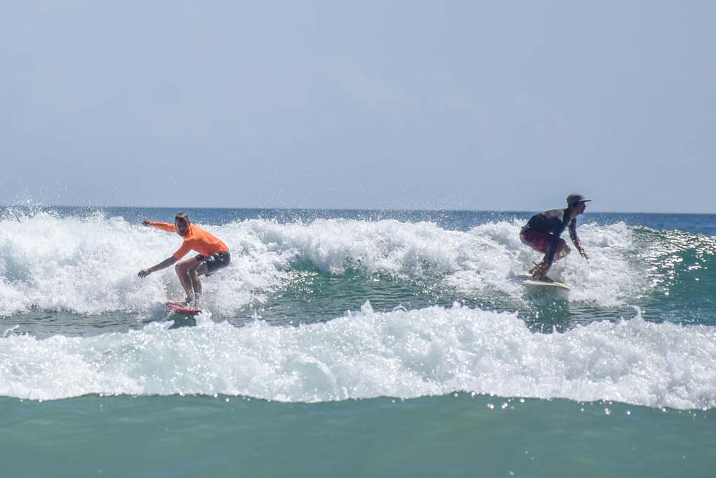 two people surfing a wave in Sa Juan del sur