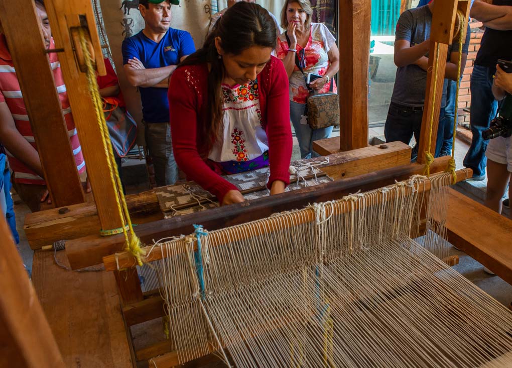 woman weaving in a traditional method