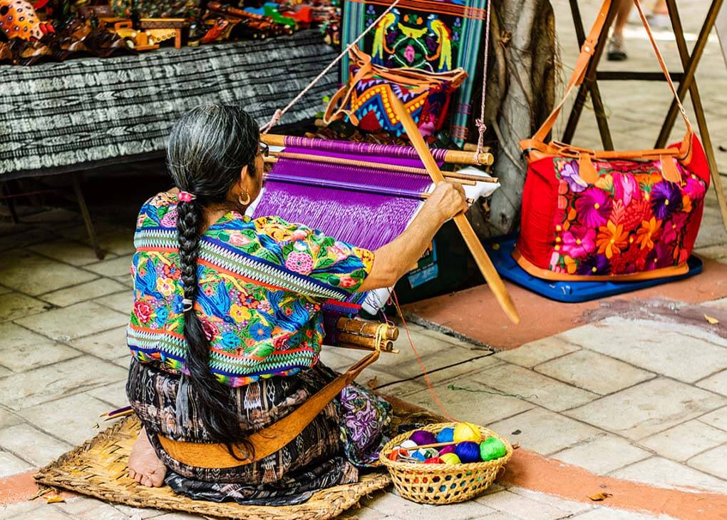 woman weaving in a traditional way in Guatemala