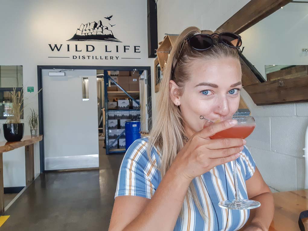 Bailey drinks a cocktail at Wild Life Distillery in Canmore