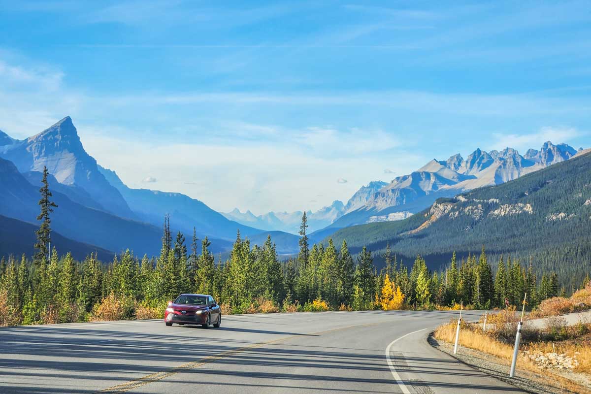 A car drives along the Icefields Parkway