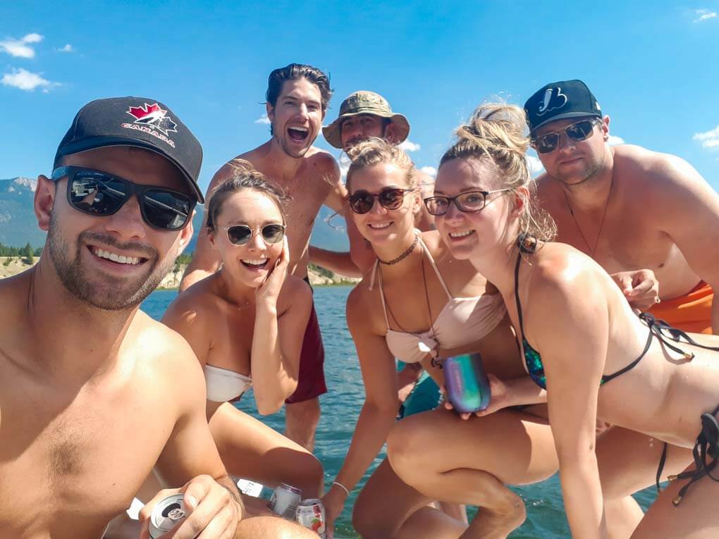 A group of people take a selfie on their boat on Lake Windermere, BC