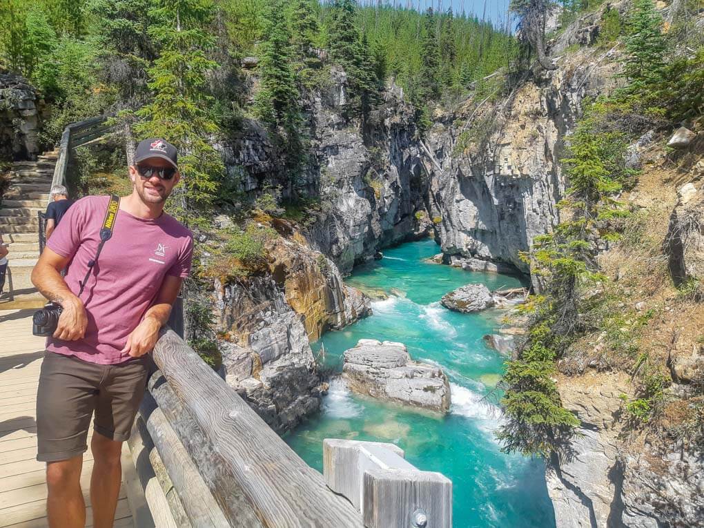A man stands on a bridge at Marble Canyon in Kootenay National Park