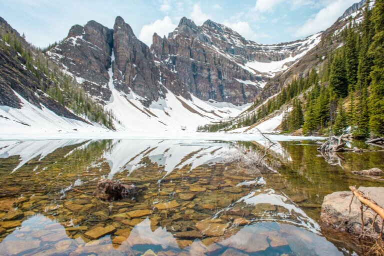 A panoramic photo of Lake Agnes with The Devils Thumb Mountain summit in the background