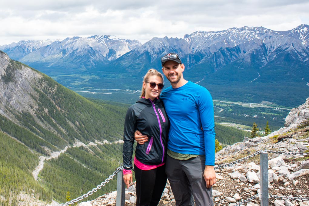 Bailey and daniel from Destinationlesstravel standing on the first viewpoint on the trail to Ha Ling Peak, Canmore