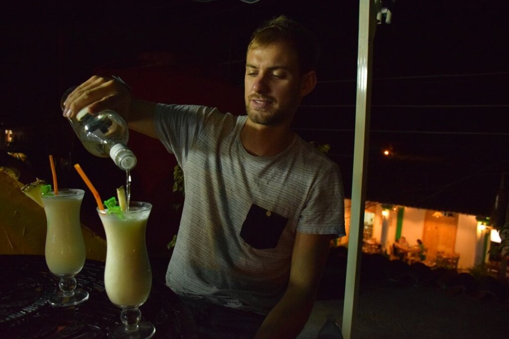 pouring rum into a pina colada in Havana, Cuba