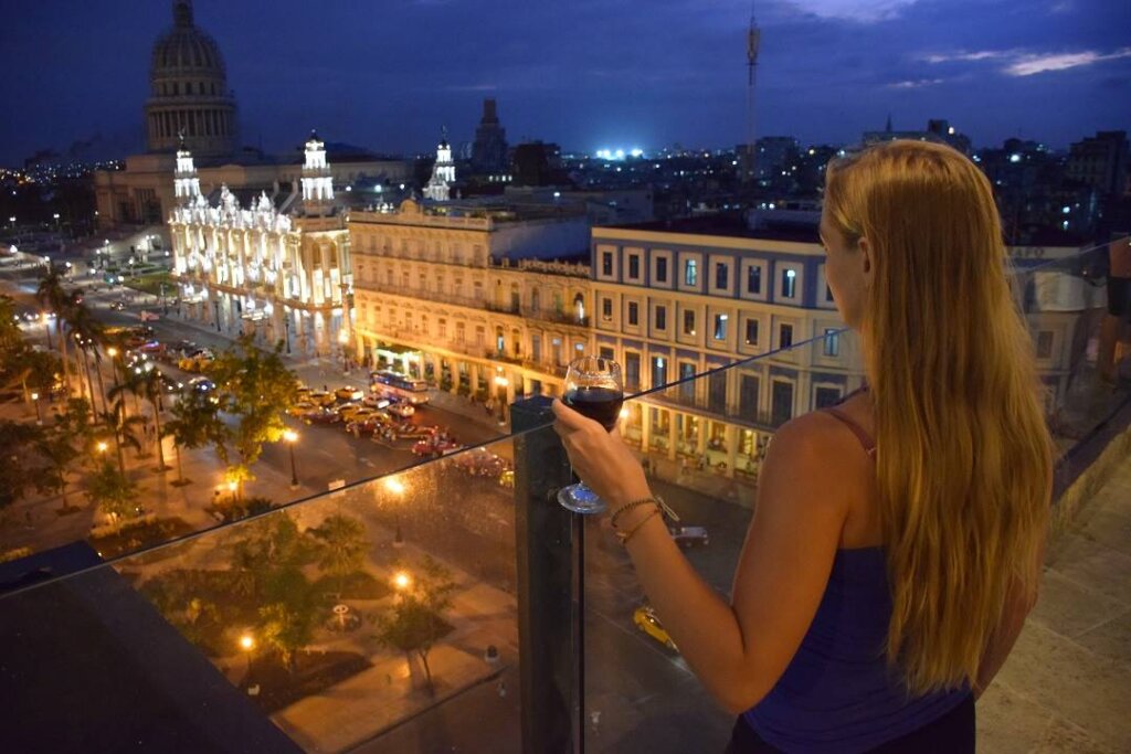 bailey drinking wine and taking in the view of Havana from the central hotel