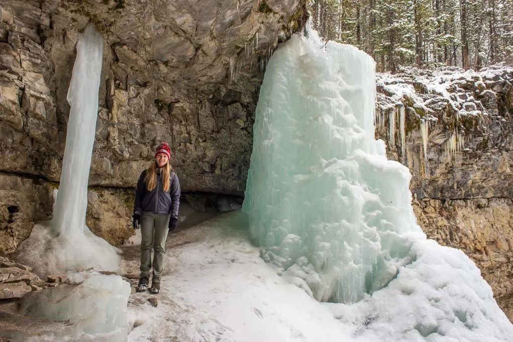 A lady poses for a photo with Troll Falls