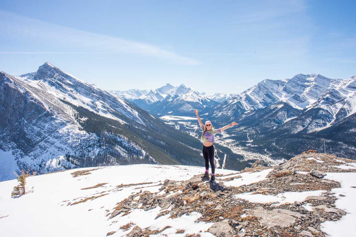 Bailey stands at the summit of East End of Rundle in Canmore